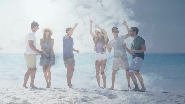 Friends moving in rhythm on sunny beach for travel, left man guiding twirl, smoke overlay drifting