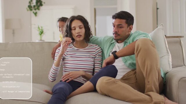 Woman holding head man consoling on sofa health overlays on couple child entering jumping cheering