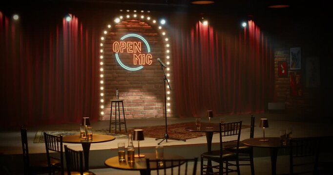 Empty Comedy Club Stage Stands Ready for Open Mic Night, With a Lone Microphone,  and Glowing Neon Sign Under Warm Lights in a Cozy Bar Venue, Awaiting the Next Standup Set With No People Present.