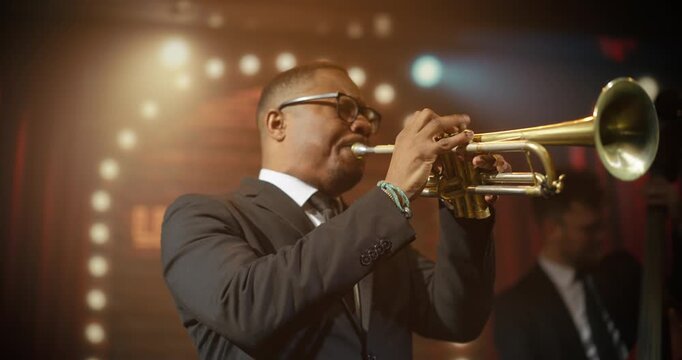 Portrait of Black Male Trumpeter Doing Solo Live Jazz Band on a Bar Stage, Playing a Soulful Song at a Concert Event While the Audience Enjoys the Music. Moving Stylish Medium Closeup