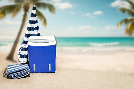 Beach umbrella and portable cooler placed on hot sandy beach under bright sunlight. The scene captures relaxed summer atmosphere with clear blue sky and seaside vibes. Summer and vacation concept.