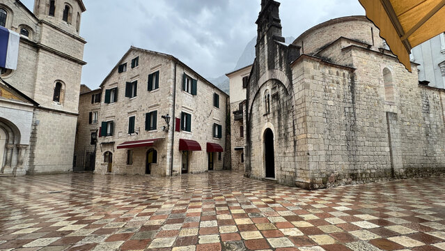 Trg od Oružja in Kotor with Saint Tryphon Cathedral and St Luke Church in rain