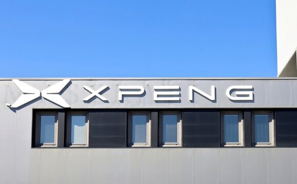 Tavagnacco, Italy. April 26, 2026. Xpeng Motors logo and brand name on the facade of the official car dealership.