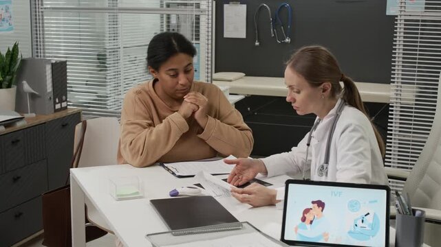 Female gynecologist supporting frustrated woman getting emotional after discovering results of ultrasound during her visit to reproductive center