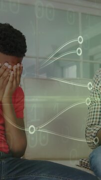 Vertical video: Father turning and reaching to comfort child covering eyes, health overlay pulsing