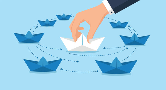 Large hand choosing white paper boat among circle of blue paper boats representing leadership and selection process.