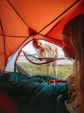 Family camping vacations - child peeking into tent to wake her mother, travel lifestyle outdoor kid and parent enjoying summer holidays adventure trip happy candid emotions bonding moments