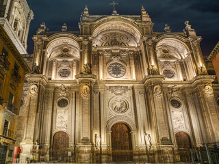 Obraz premium Illuminated Historic Granada Cathedral Facade At Night Showing Ornate Stone Architecture And Sculptural Details