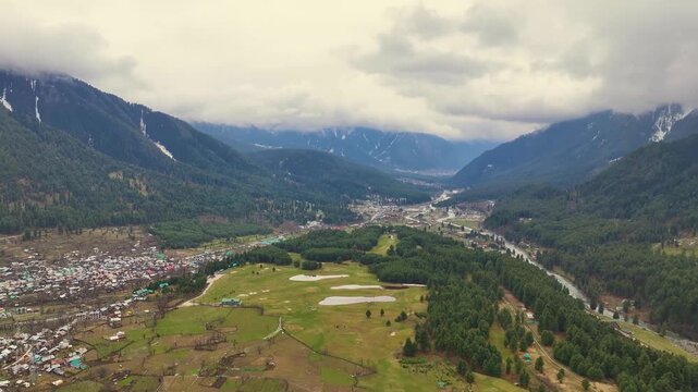 Epic backward aerial reveal of Pahalgam golf course and Lidder valley.