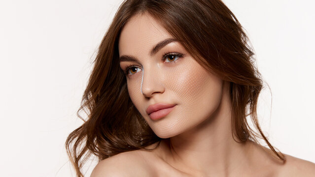 Brunette woman poses with dotted facial scan grid across cheeks and nose on clean white background. Made for skincare diagnostics, beauty tech and cosmetic clinic marketing.