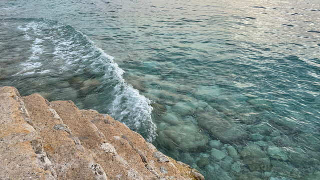 Dobra Voda coastal steps meeting clear Adriatic Sea water and gentle waves