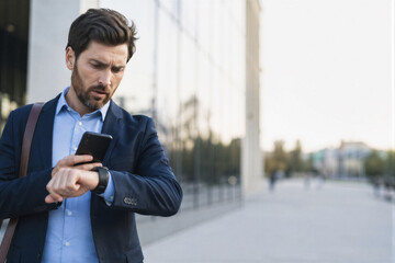 Fototapeta premium Business man checking watch in city as time management and productivity concept 