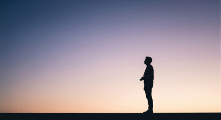 Fototapeta premium Photographer silhouette at sunset horizon as travel freedom and creative lifestyle concept 
