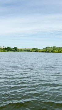 A peaceful walk unfolds along the Ternopil Pond in Ternopil, Ukraine, where calm waters and lush surroundings create a serene urban retreat.
