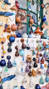 Greece Crete Margarites authentic village Vertical 4K Video of Colorful Ceramic Plates and Pottery on Artisan Shop Wall Traditional Greek Craft and Mediterranean Decor No People