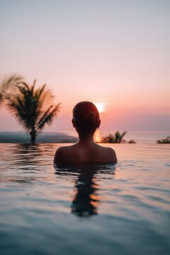 Woman relaxing in infinity pool at tropical resort during sunset, luxury vacation travel and wellness spa отдых for hotel advertising and tourism promotion