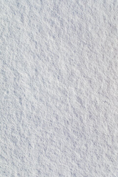 Abstract background of clean white snow texture with natural patterns and shadows