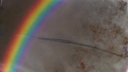 Naklejka premium Rainbow over Dust Storm: A vibrant rainbow arcs gracefully across a swirling dust storm, painting a scene of natural wonder and resilience in the face of adversity. 