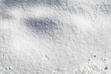 Abstract snow texture detail with soft light and shadows creating depth. © vegefox.com