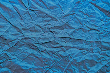 Fototapeta premium Vibrant blue silk taffeta textile with folds wrinkles and glossy texture.