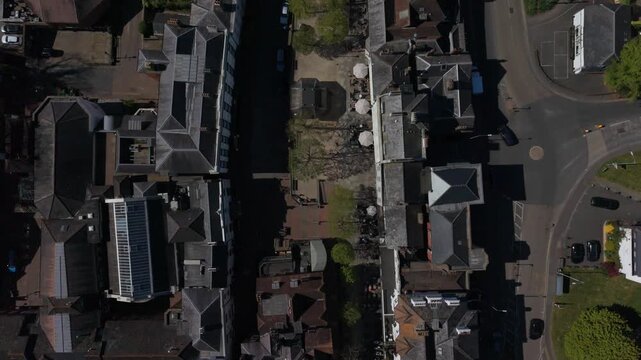 Historic Pantiles Royal Tunbridge Wells aerial top down view. Old town square with restaurants, coffee shops and hotel. Quiet outdoor sitting under the trees in springtime. Road with cars in motion.