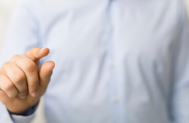 Naklejka premium Close-up of a man's hand pointing with the index finger. Focus on the gesture.