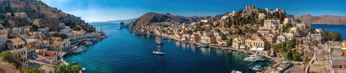 Fototapeta premium Picturesque coastal town nestled between hills, boats in blue harbor