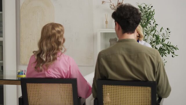 Young couple sharing positive therapy results with reproductive endocrinologist