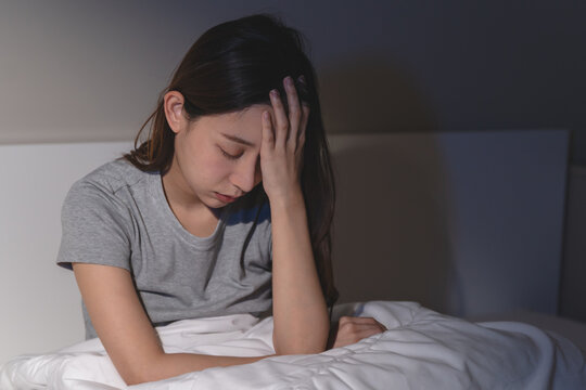 Anxiety disorder on insomnia woman concept, sleepless Woman open eye awakening on the bed at night time can't sleep from symptom of depression diseased.