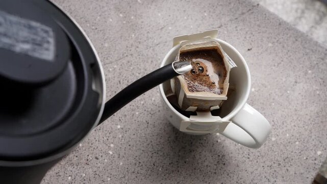 Footage of manual drip coffee brewing process with gooseneck kettle overhead.