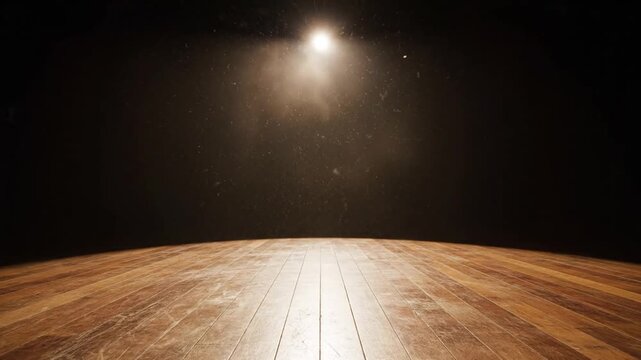 Empty wooden stage illuminated by spotlight in dark theater with dust