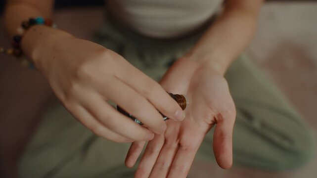 Applying essential oil to hands close up