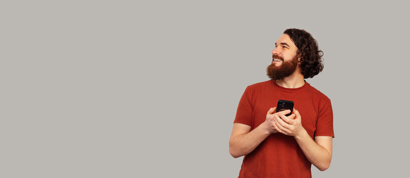 Bearded White Man Cradling Coffee Mug Content, Relaxed Gaze, Cozy Morning Mood, Warm Tones, Comfortable Break.