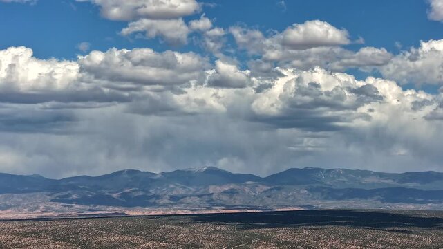 A dramatic drone hyperlapse captures rapid storm cloud movement above the summit of Mt Baldy. The turbulent sky and rugged mountain landscape create an epic nature transition and background.
