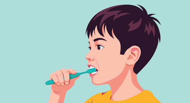 Young boy in a yellow shirt carefully brushes his teeth with a blue toothbrush against a light blue background.
