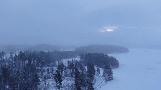 Epic Aerial View of Frozen ake and Forest Islands Durng Winter Blizzard