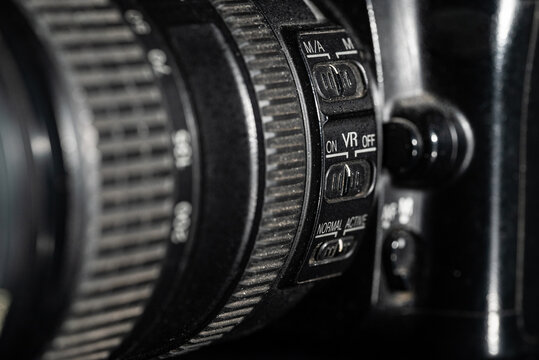 Part of dslr camera close up on black background