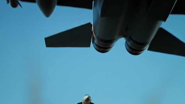 Modern fighter jet deploying swarm of guided missiles in flight