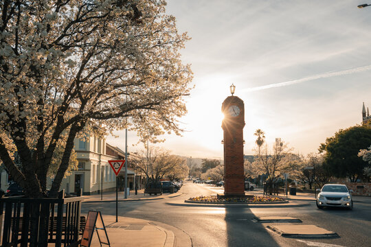 Historic clock tower with sunburst at sunset in regional country town