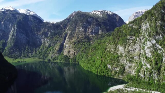 Aerial View of Dramatic Limstone Mountain Walls and Dep Green Alpine Lake