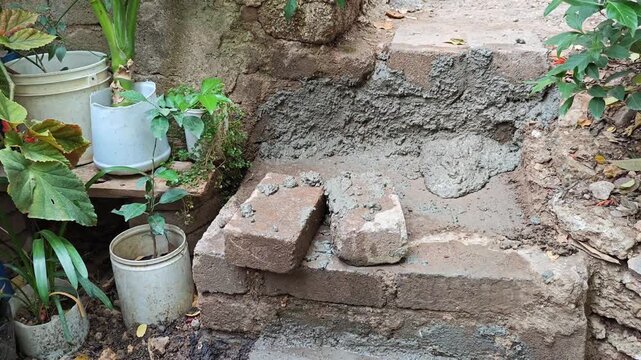 Pouring liquid cement as a sealer on a wall