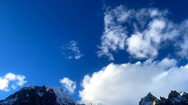 Timelapse of clouds moving between two mountains peaks in himalayas, dramatic cloud movements over mountain range