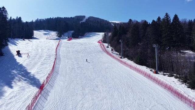 Cinematic Aerial View of Emty Snow Covered Ski Slope nd Winter Resort
