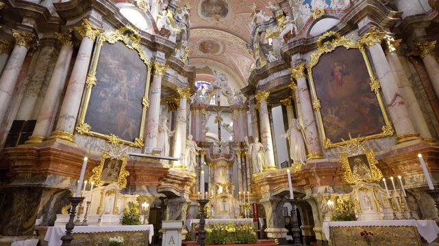  Smooth camera movement through the interior of the Dominican Church of the Holy Spirit revealing the historic golden altar and Baroque details-Vilnius, Lithuania 2026 05 15