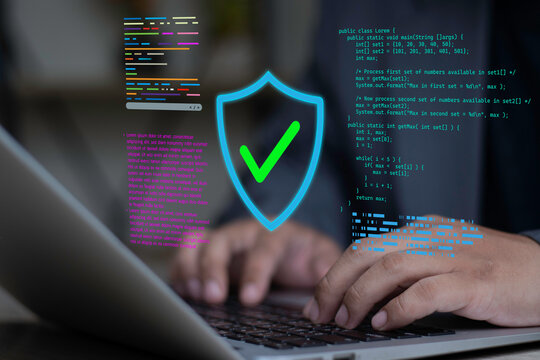 Secure software development and coding application. Programmer uses laptop for source code protection and system security solution.
