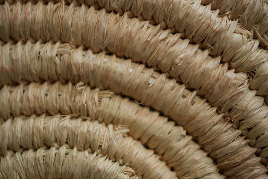 round macro texture of summer brown paper hat as background, round close up texture of panama hat, panama hat paper