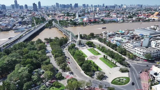 Memorial Bridge or Phra Phuttha Yodfa Bridge crossing river with steel structure and moving vehicles.