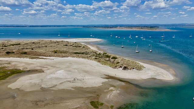 Aerial view from drone of East Head sand dune spit and coastal salt marsh at West Wittering, West Sussex