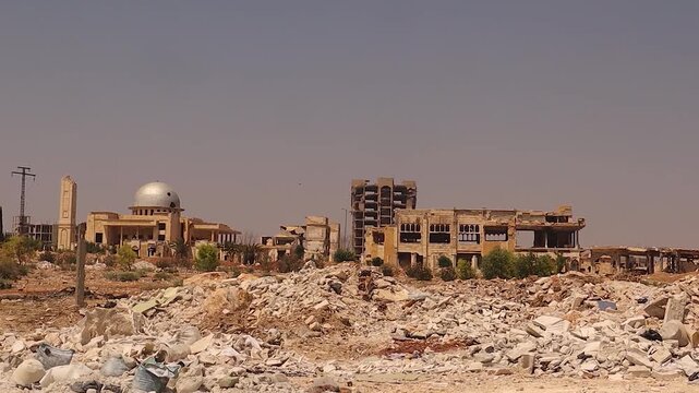 War in Aleppo, Syria unfolds in a cinematic pan revealing shattered buildings, vast rubble and collapsed power lines. Powerful footage for news, documentary, conflict analysis and humanitarian story