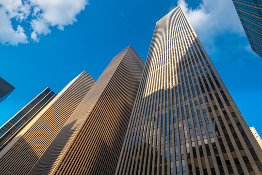 The massive scale of high rise commercial buildings defines the urban landscape of Midtown Manhattan along the Avenue of the Americas corridor, New York